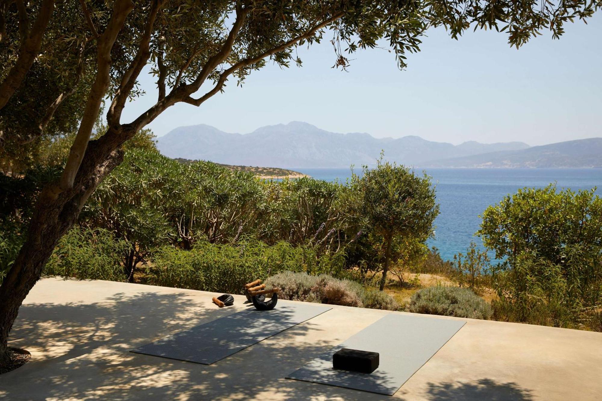 Minos Palace Resort - Adults Only Agios Nikolaos  Bagian luar foto A woman practicing yoga on a yoga mat